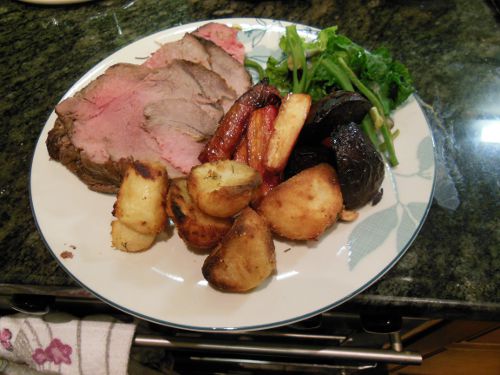 The finished roast beef, with honey roasted carrots, parsnips and beetroot, roast potatoes, runner beans and flower sprouts